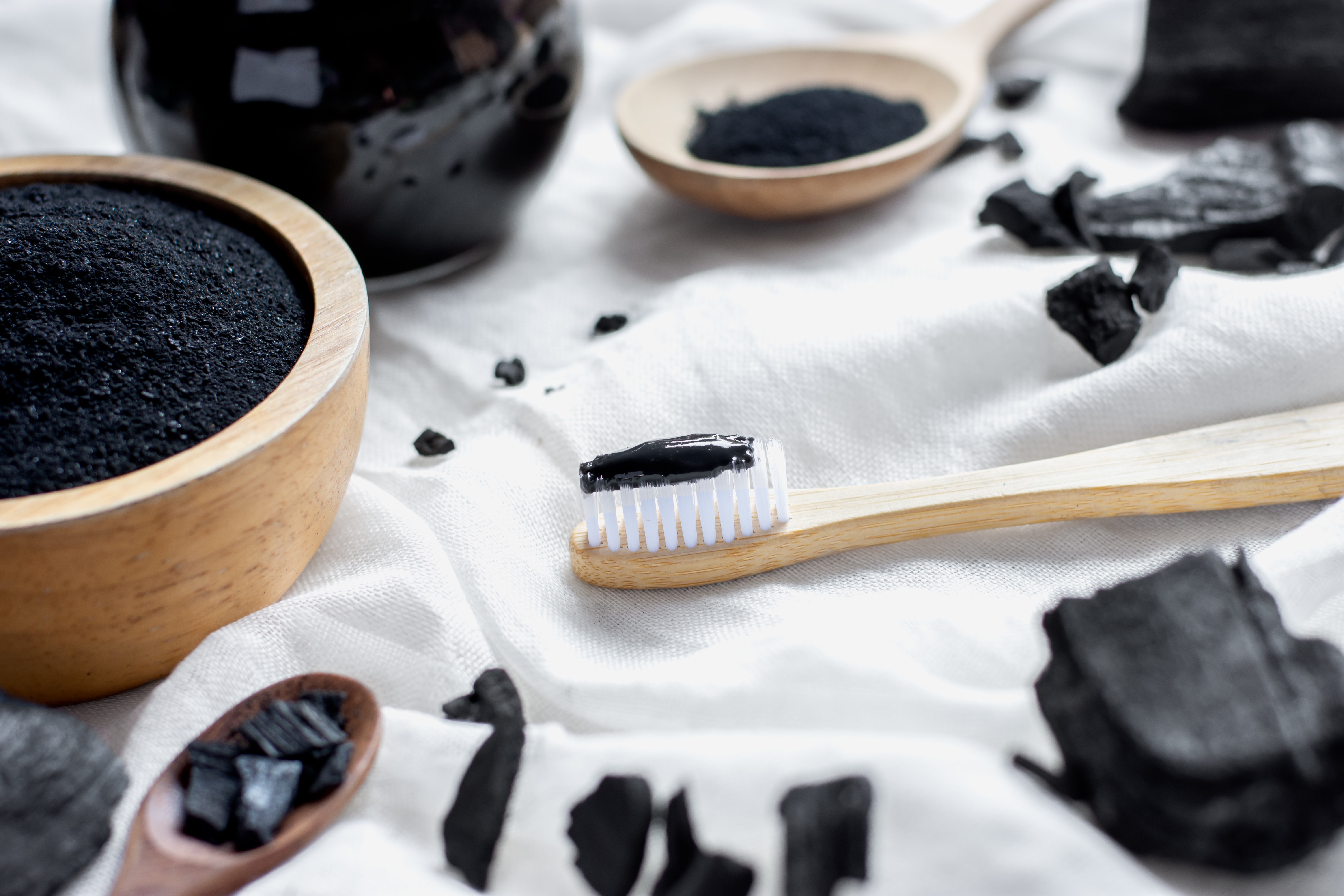 black-charcoal-toothpaste-with-finely-ground-charcoal-is-placed-white-cloth