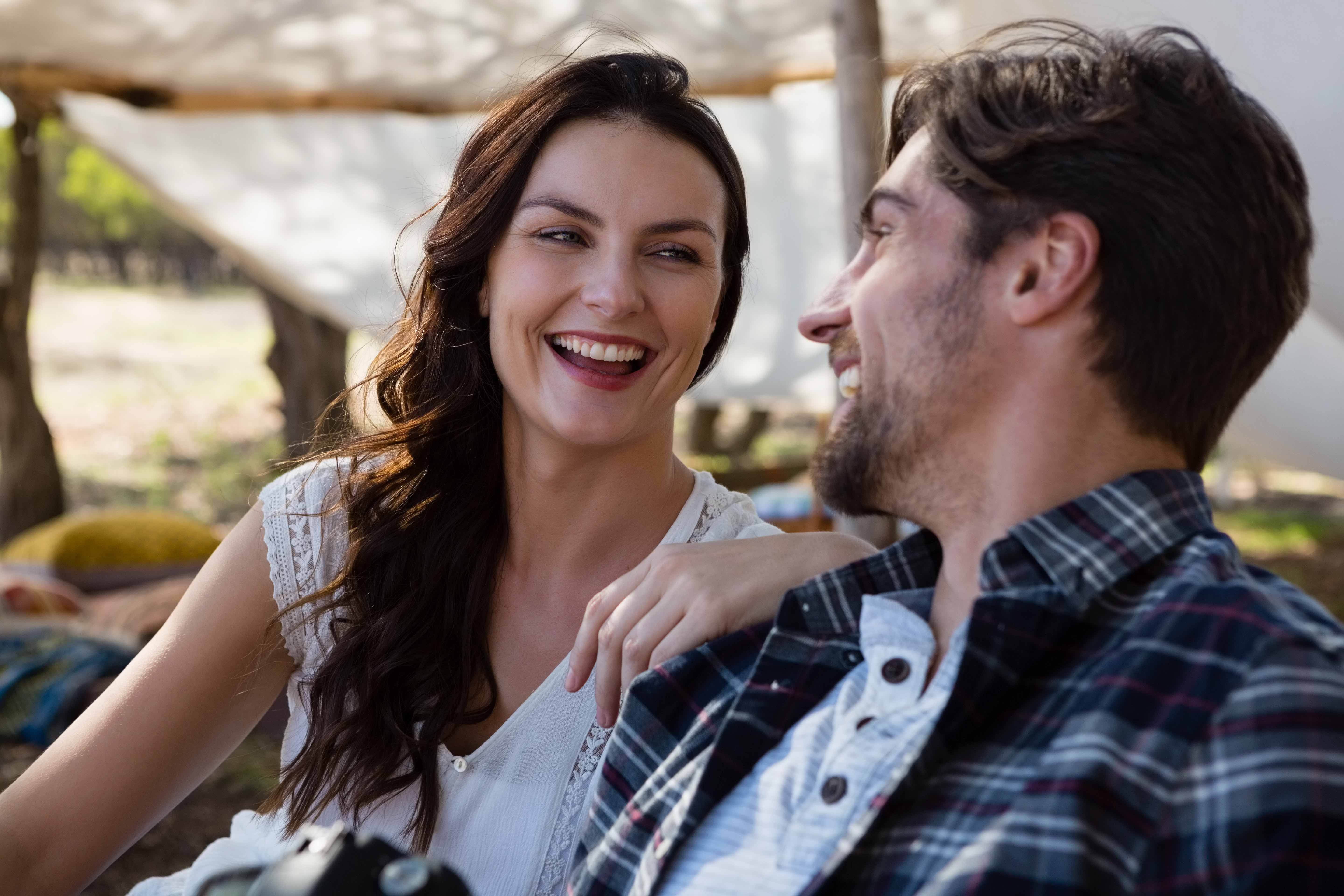 cheerful-couple-outside-tent